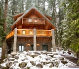 Mt. Baker Lodging - Cabin 47 - This 3-story, 3-bedroom, 1 3/4-bath log home blends modern convenience with rustic charm! The 1st floor includes a family room with a freestanding gas fireplace and a laundry room with a full size washer/dryer. The main floor features a fully equipped kitchen, an open living/dining area with a wood burning fireplace, a 3/4 bath, and french doors that access a balcony with mountain views. The 3rd f