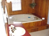Suite 4 jacuzzi tub - Queen canopy bed, gas fireplace, 2 person jacuzzi bath in the attached private bathroom.