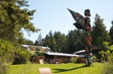 The Totem Pole and lawn - A view of the lodge from the beach showing the totem pole and lawn in front of the lodge, going down to the beach.